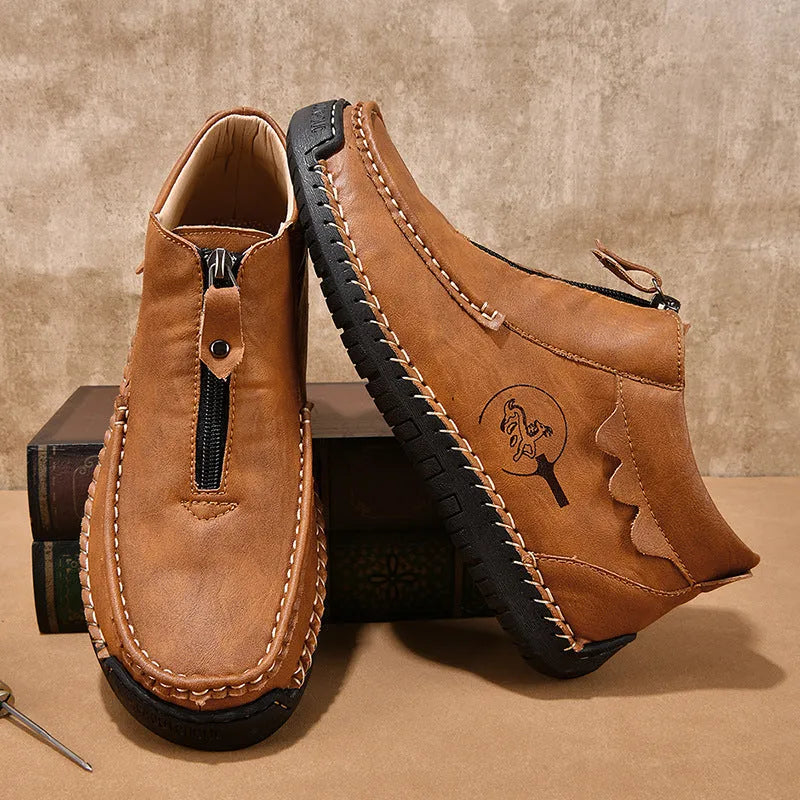 Men's black slip-on leather loafers with round toe and sewn sole on a rubber outsole.