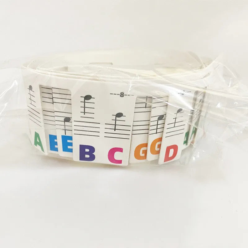 White cardboard piano keyboard stickers showing staff notation for 88 keys, with black notes and colour note bar options
