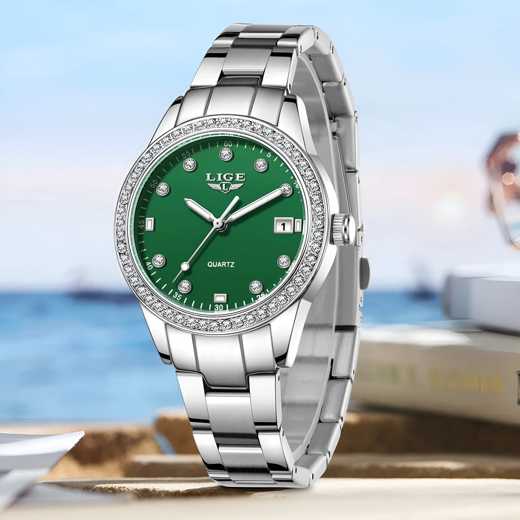 Silver fashion quartz watch with diamond bezel and round white dial on a coloured strap.