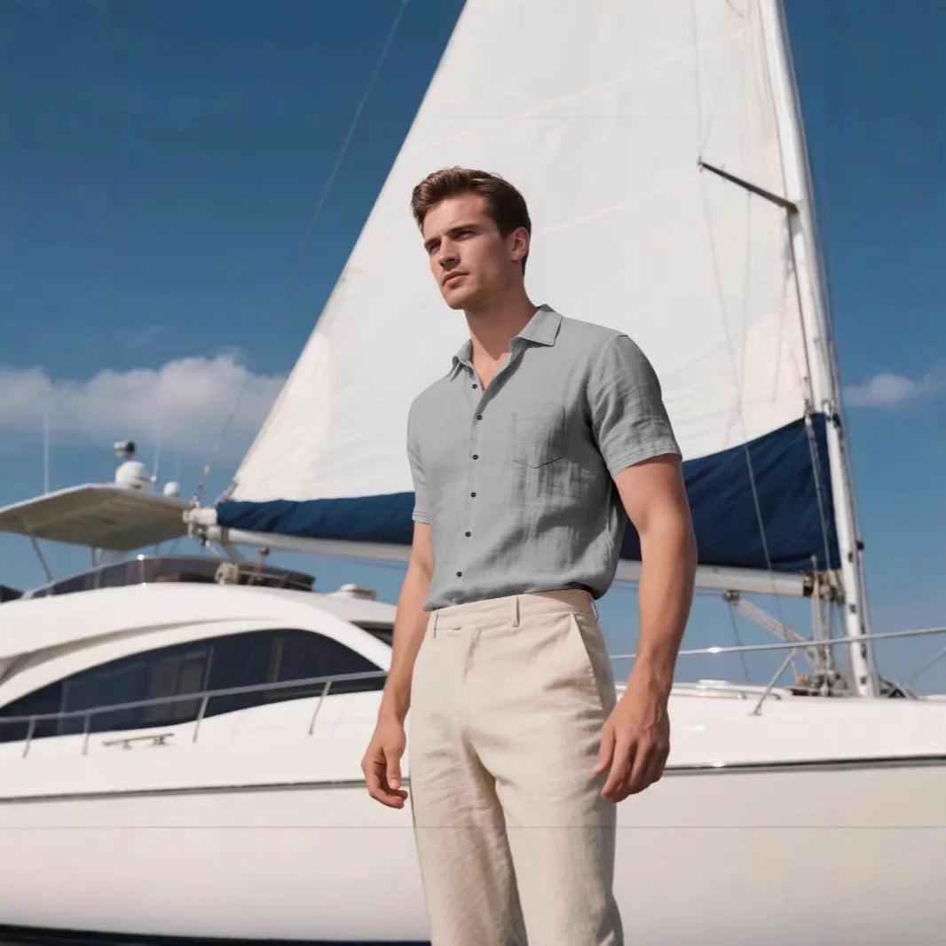 Man wearing a loose-fit grey short-sleeve linen blend shirt for casual leisure.