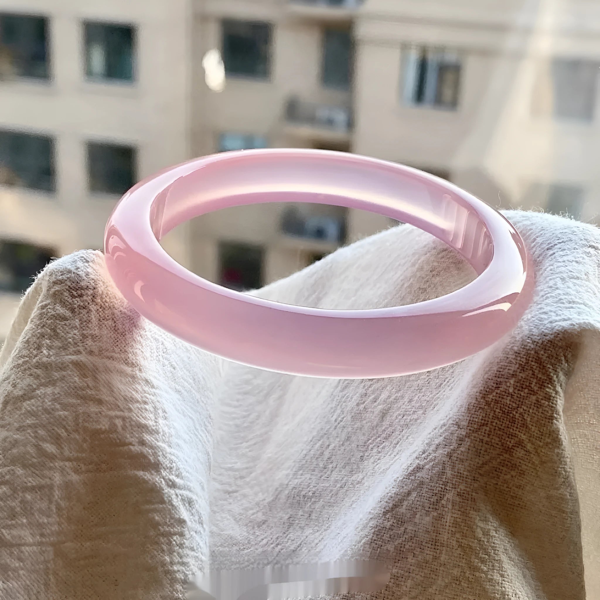 Natural agate wide tire bracelet shown in pink, available in sizes 52mm to 62mm.