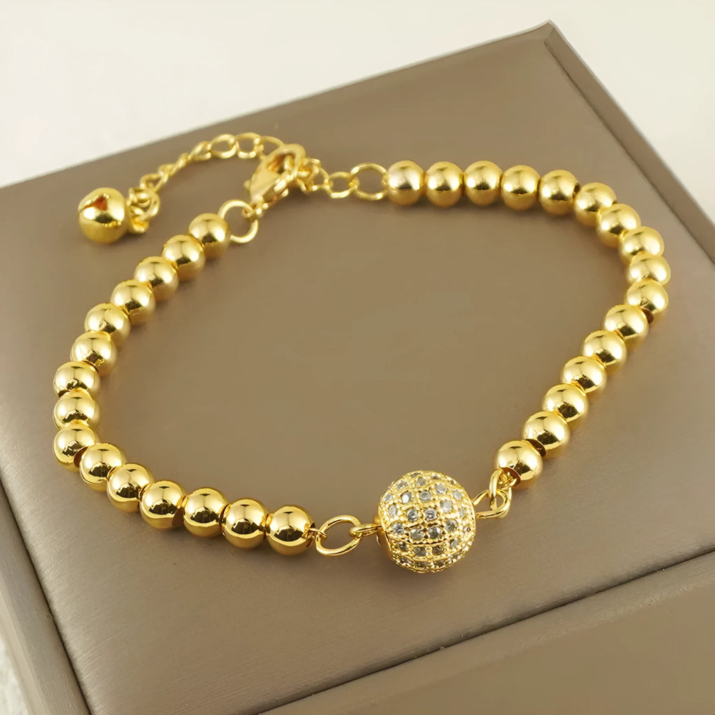 Close-up of a women's copper heart bracelet with a round zircon stone in an Arabic style.