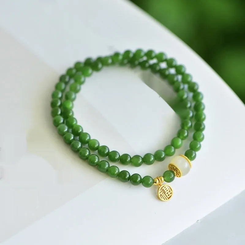 Natural Hetian jade double circle bracelet with 6mm beads and a carved fu character charm.