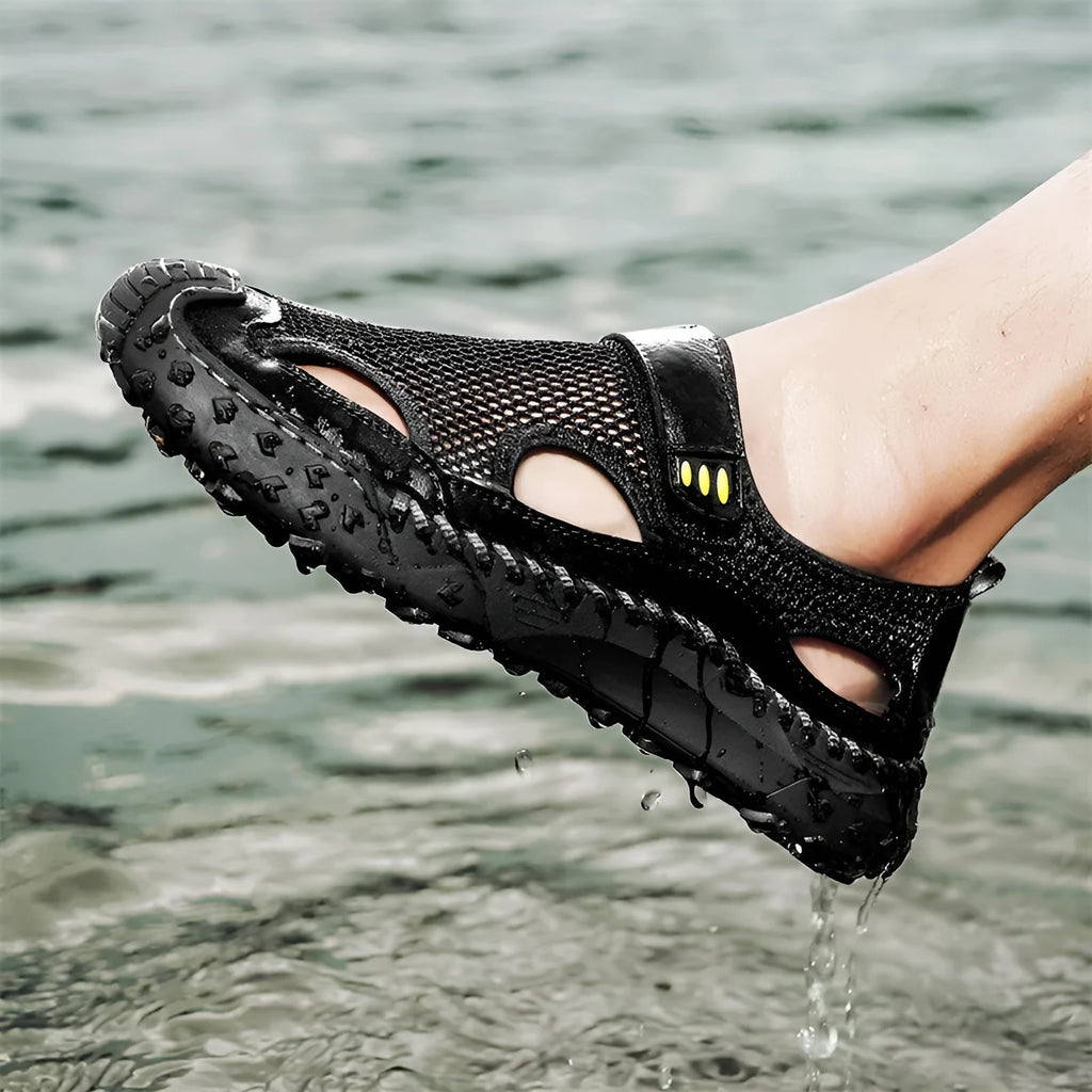 Men's black mesh sandal with Velcro strap on a rubber sole