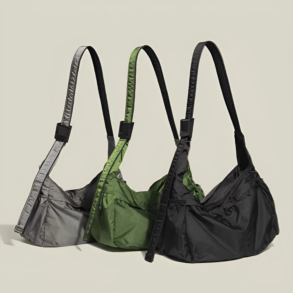 Black nylon waterproof sports style messenger bag with horizontal square design and shoulder strap