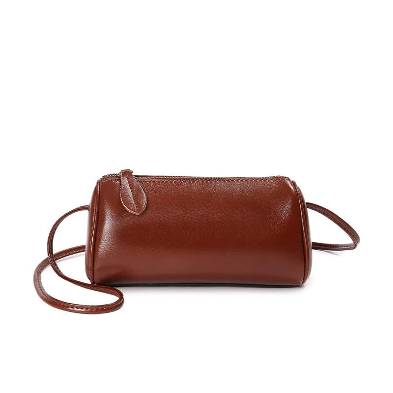 Genuine first layer cowhide crossbody bag in cylinder shape with sewing line details, available in six colours