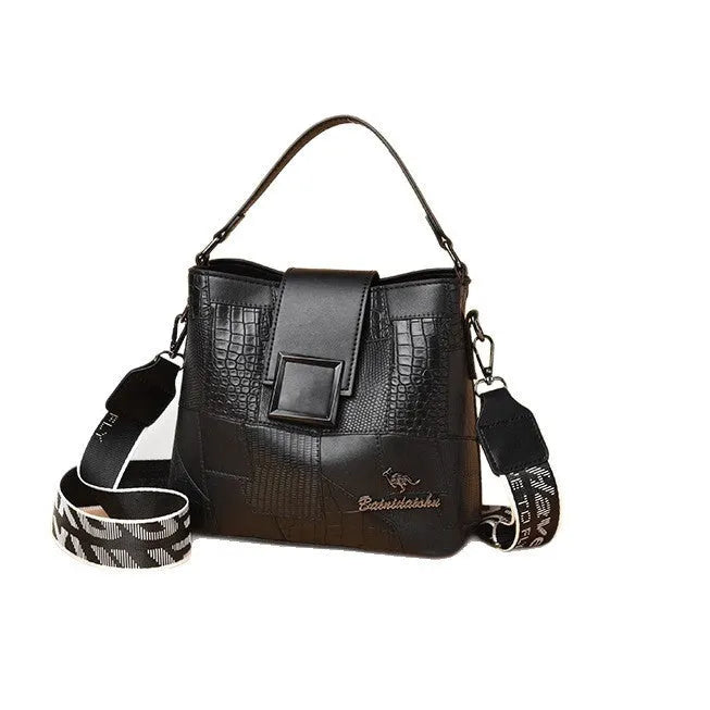 PU leather crossbody handbag with sewing line detail in brown, showing outer sandwich pocket and adjustable strap against neutral background