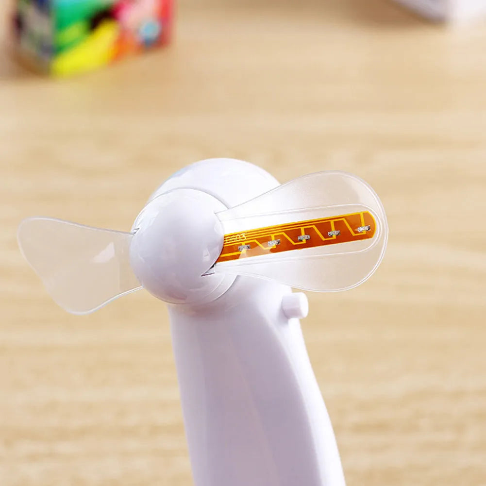 White mini handheld fan showing blue and red LED lights forming 'I Love You' message on its front.
