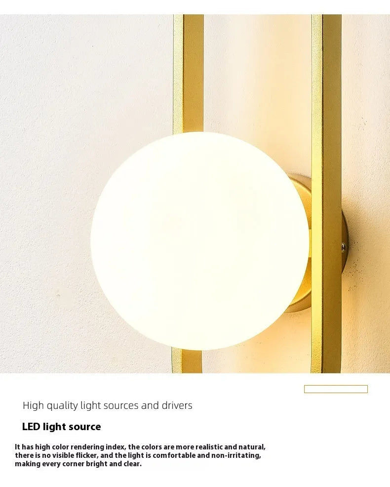 Modern minimalist wall lamp with clear glass shade and black iron mount, showing three light colour settings.