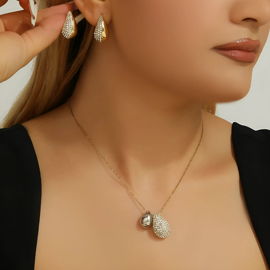 Elliptical necklace and earring set with full diamond droplet shape, silver-tone finish