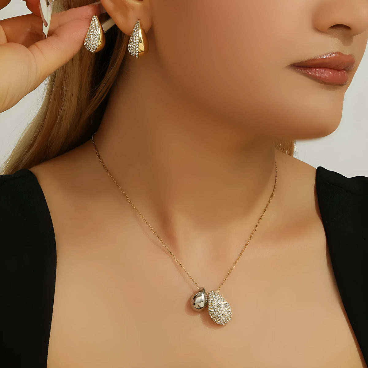 Elliptical necklace and earring set with full diamond droplet shape, silver-tone finish