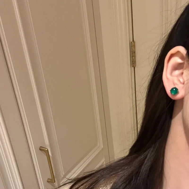Round egg surface chalcedony stud earrings with four claw settings in emerald green, milk white, or pink purple.