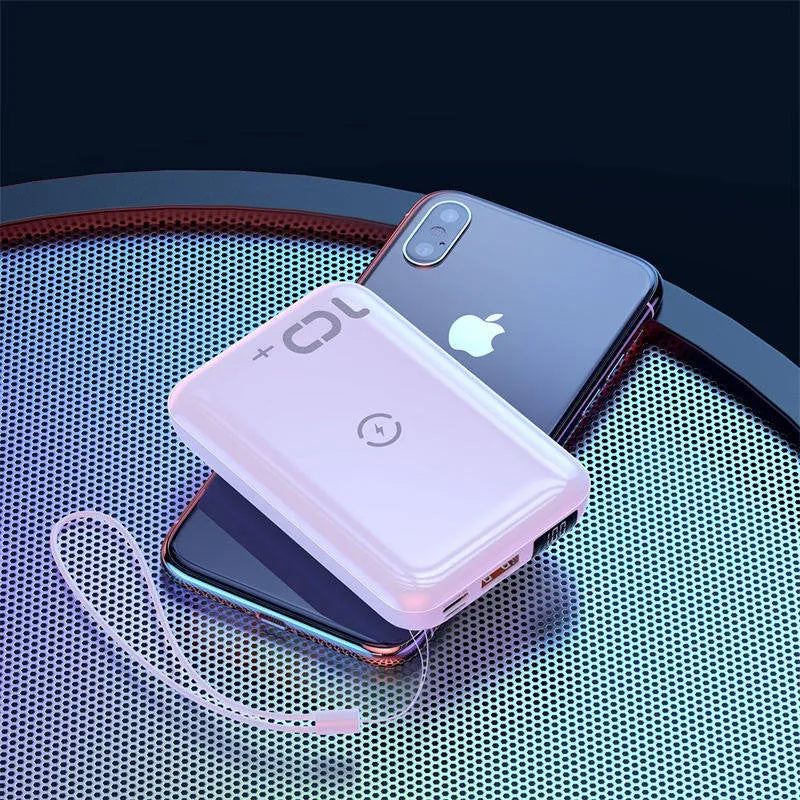 Small square black portable power bank with LED digital display on a table.