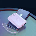 Small square black portable power bank with LED digital display on a table.