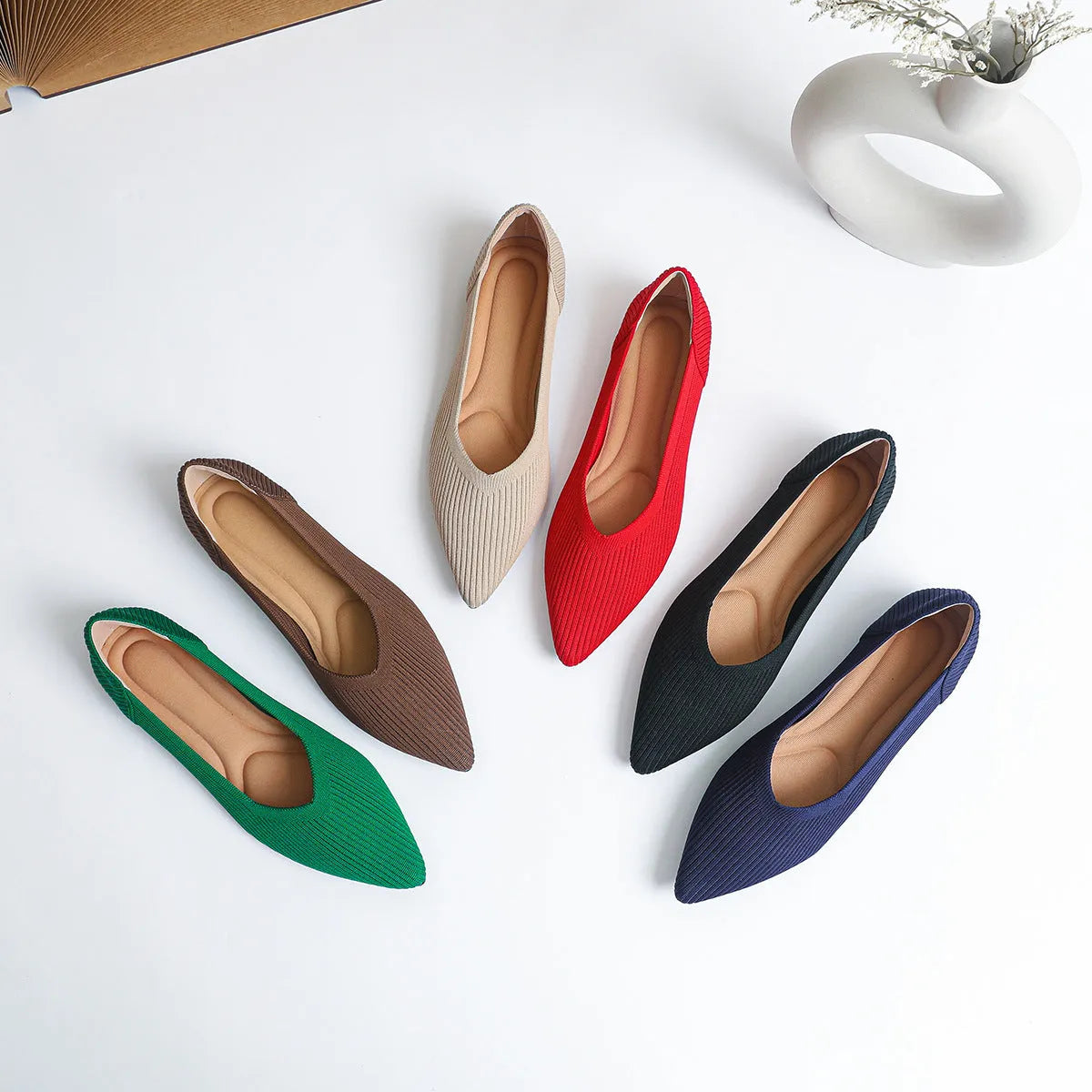 Women's apricot knit flat pumps with pointed toe and oversleeves design on a rubber sole.
