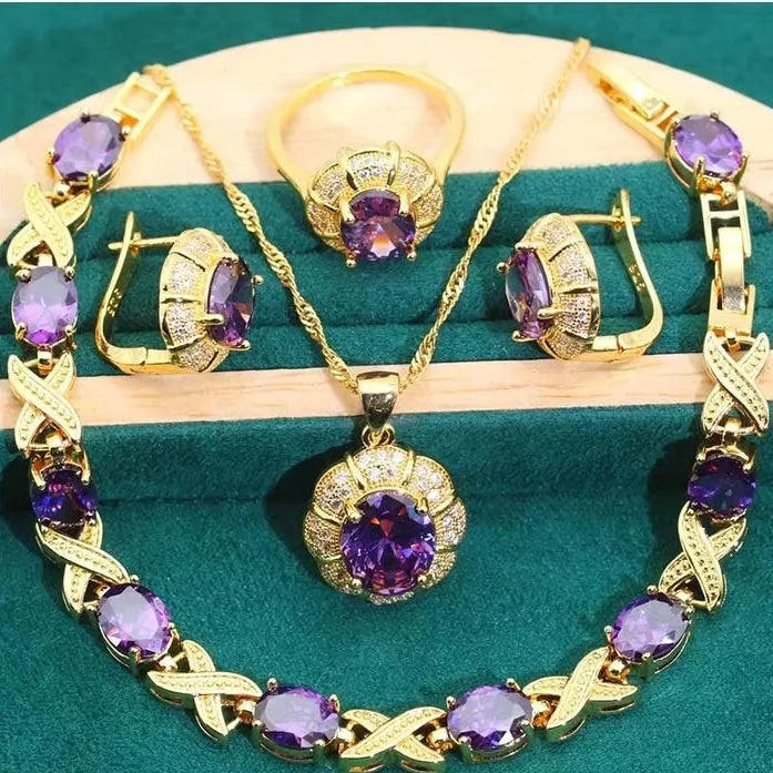 Gold plated jewellery set with colourful cubic zirconia stones, showing necklace, earrings, ring, and bracelet.
