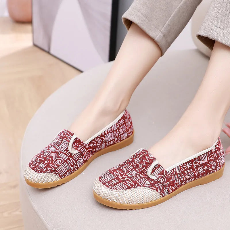 Women's ethnic style flat cloth shoes in red with colour stitching and a beef tendon sole.