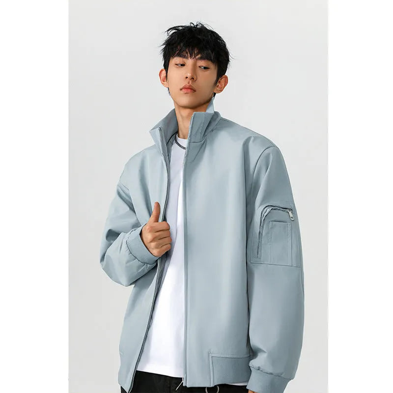 Men's large size multi-pocket short flight jacket in black, loose fit, polyester fiber fabric with visible pockets.