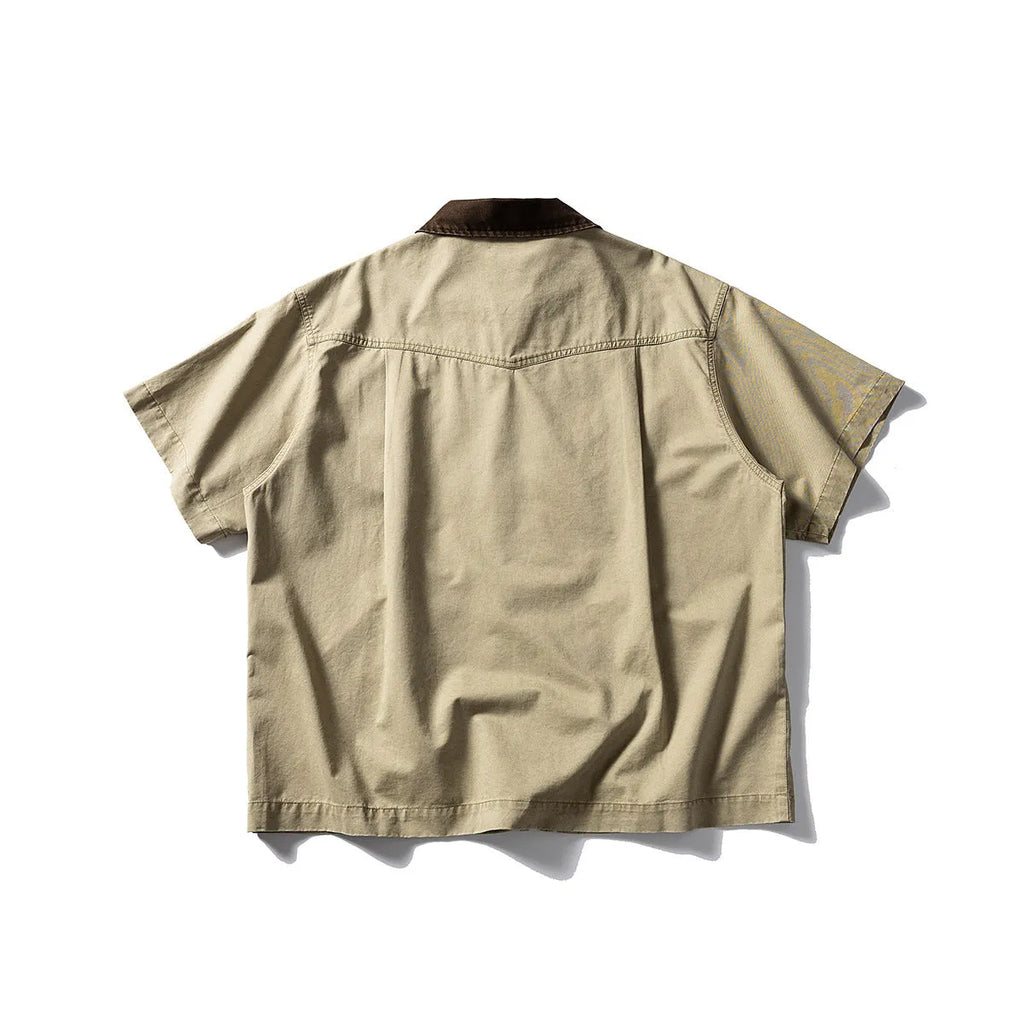 Short sleeve loose cotton overalls shirt in khaki colour on a hanger