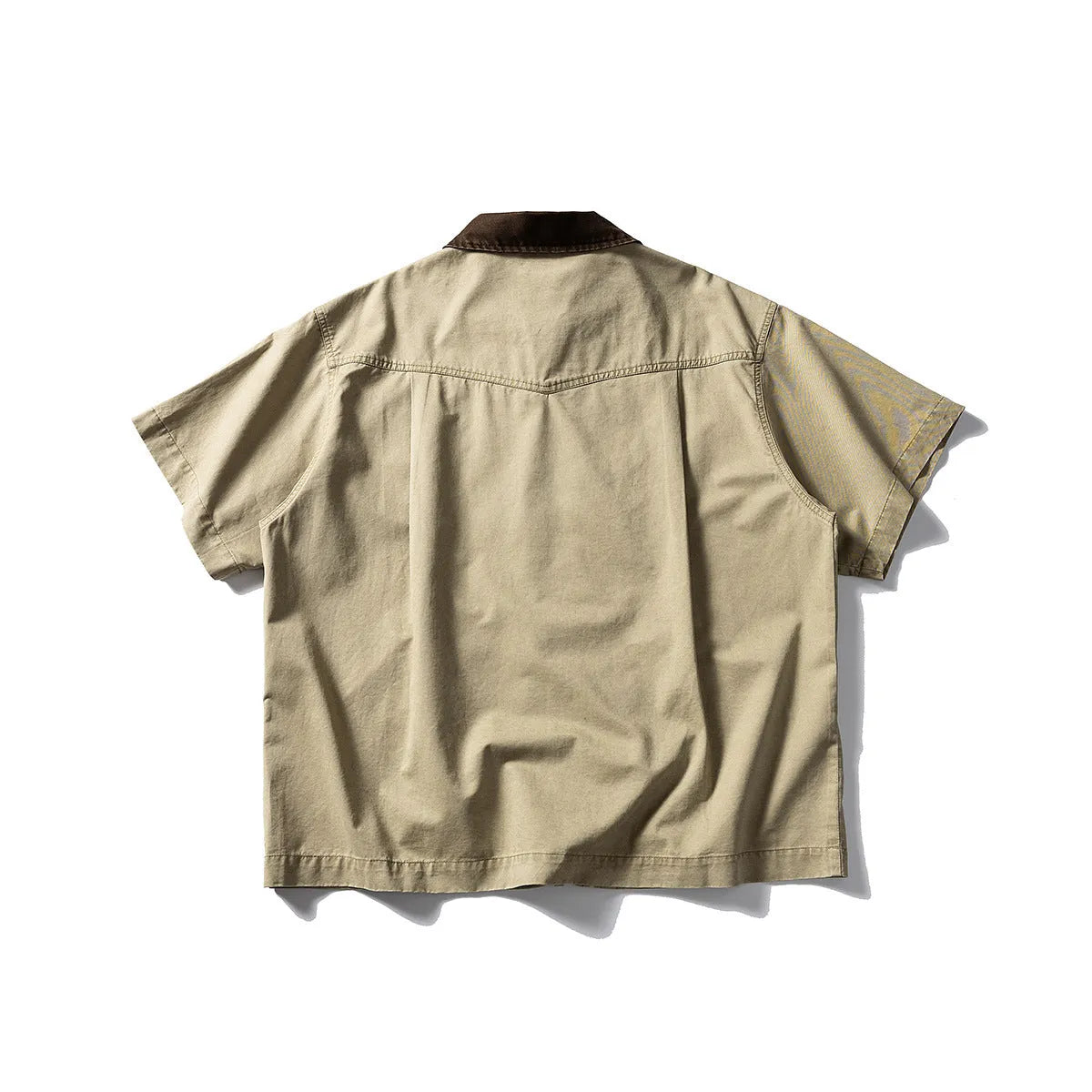 Short sleeve loose cotton overalls shirt in khaki colour on a hanger