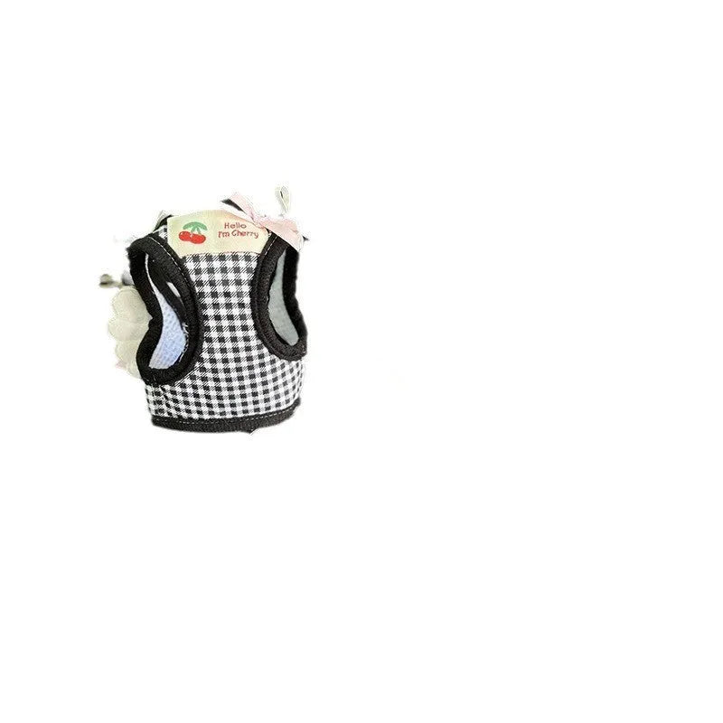 Pink and black cotton chest and back hand holding rope harness for a small dog on a white background.