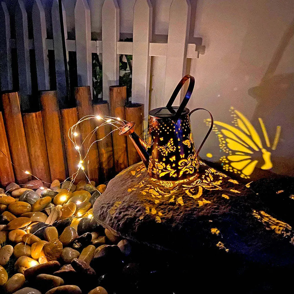 Solar-powered iron garden lamp with a tapered butterfly design emitting warm white light.