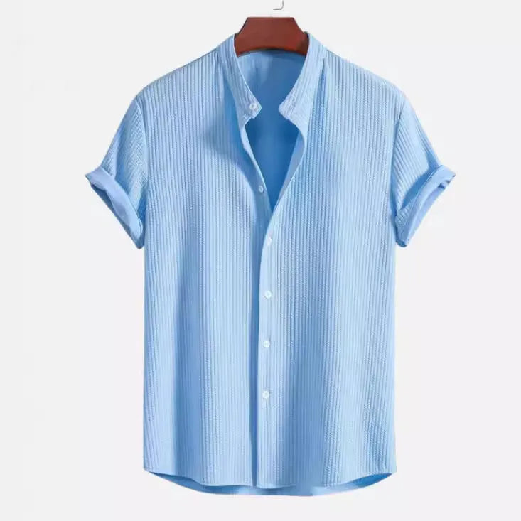 Men's loose fit short sleeve polyester shirt shown in a light blue colour on a hanger.