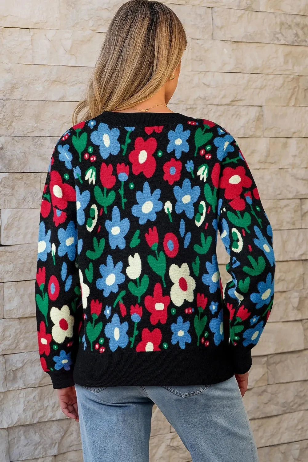 Black floral print V-neck button cardigan sweater with long sleeves and colour-block detail, laid flat