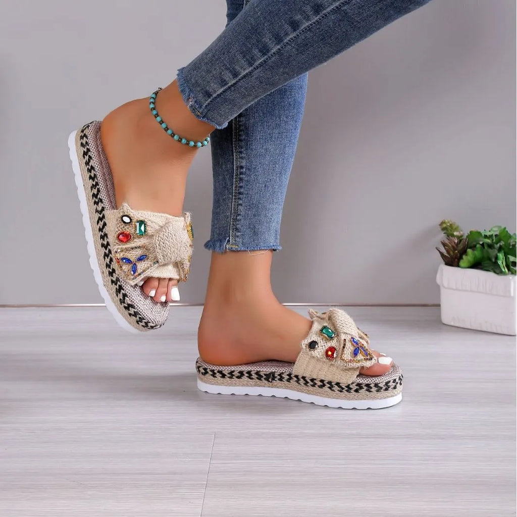 Creamy-white women's platform sandals with a cloth upper, beach bow detail, and a round toe.