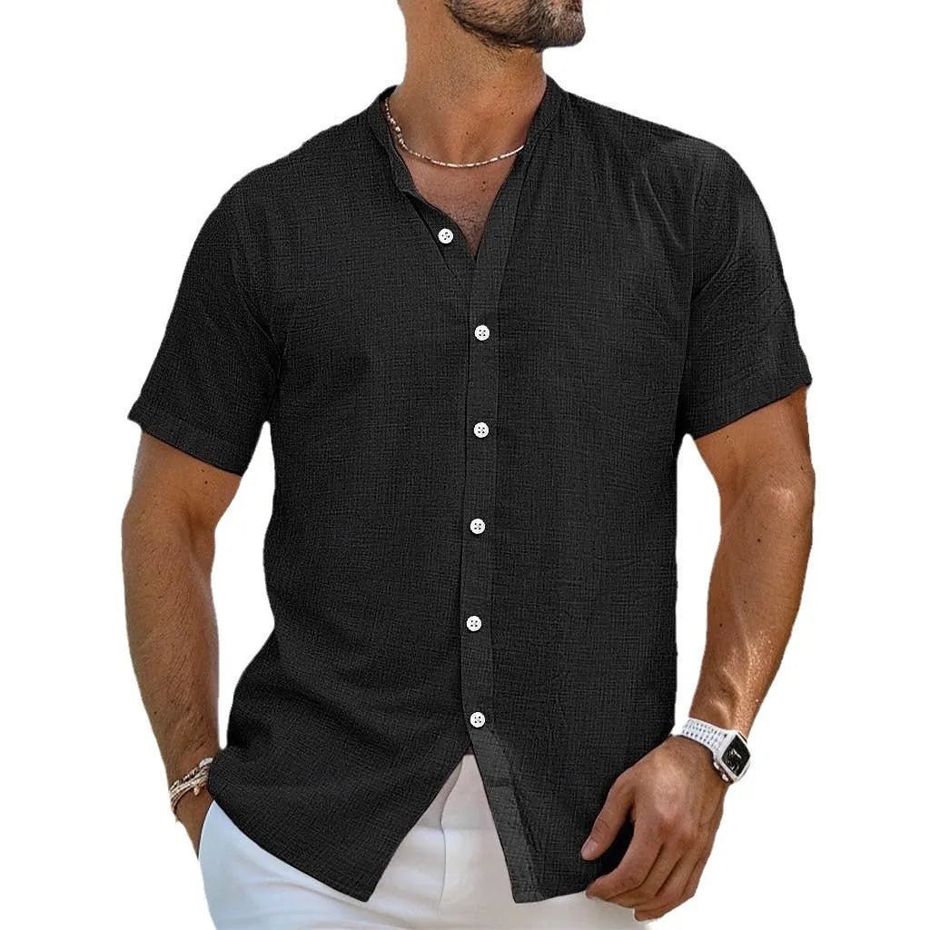 Man wearing a light blue cotton linen blend cardigan shirt with a henry collar and short sleeves.