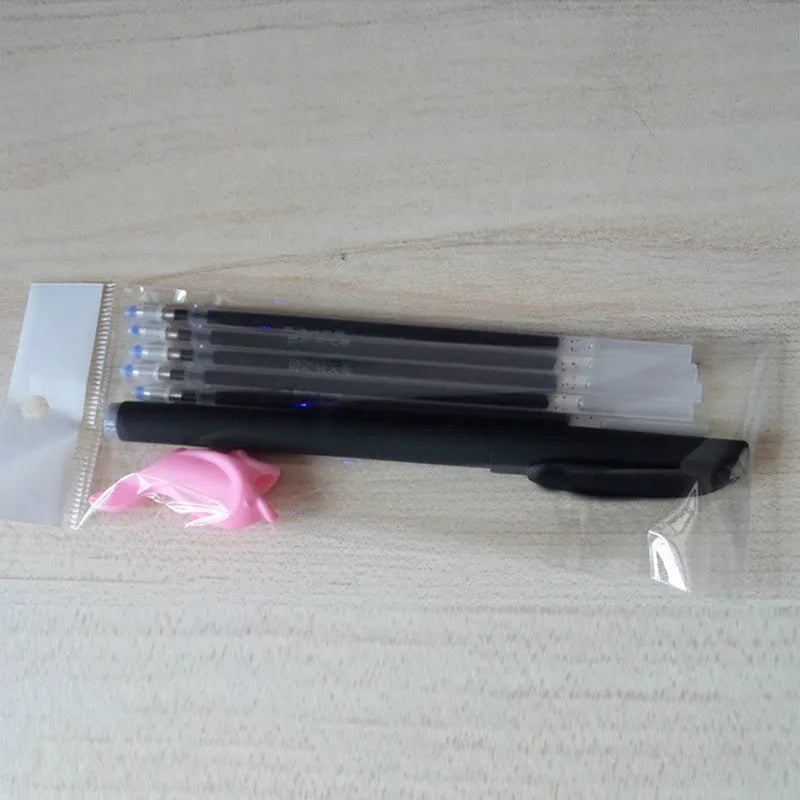 Automatic fade and disappear pen set showing pen holder, case, and eight refills on a notepad.