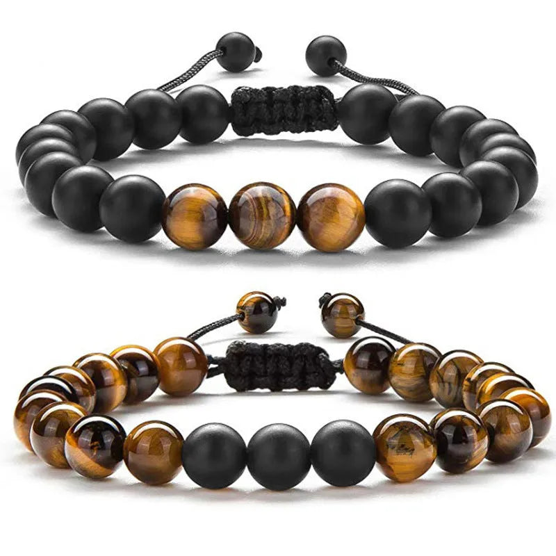 Matte black agate bead couple bracelets with geometric design on a plain background.