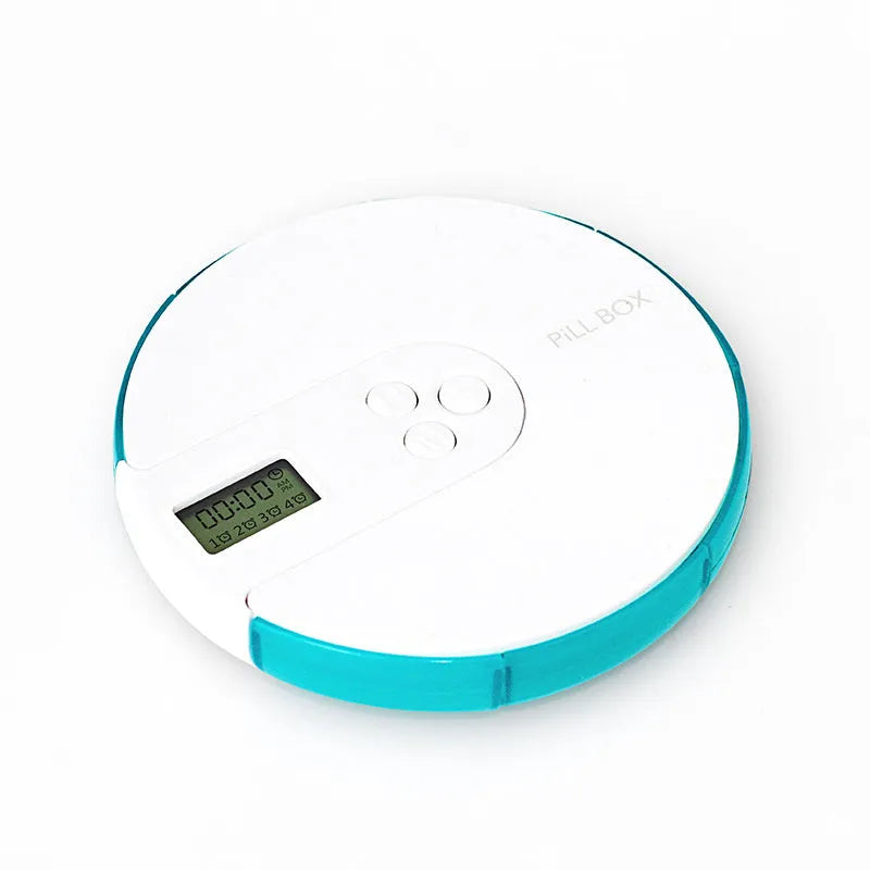 Blue weekly pill organiser with seven compartments, a digital clock display, and clear lids on a wooden table.