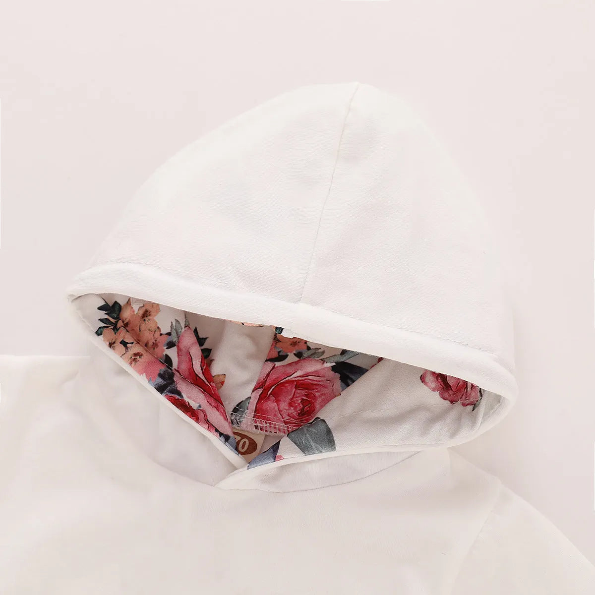 White cotton hooded tracksuit set for a baby girl, showing long sleeves and full-length trousers.