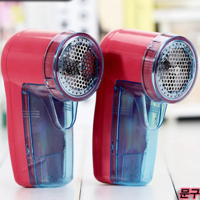Compact white handheld electric lint remover for clothing, showing fabric shaving head.