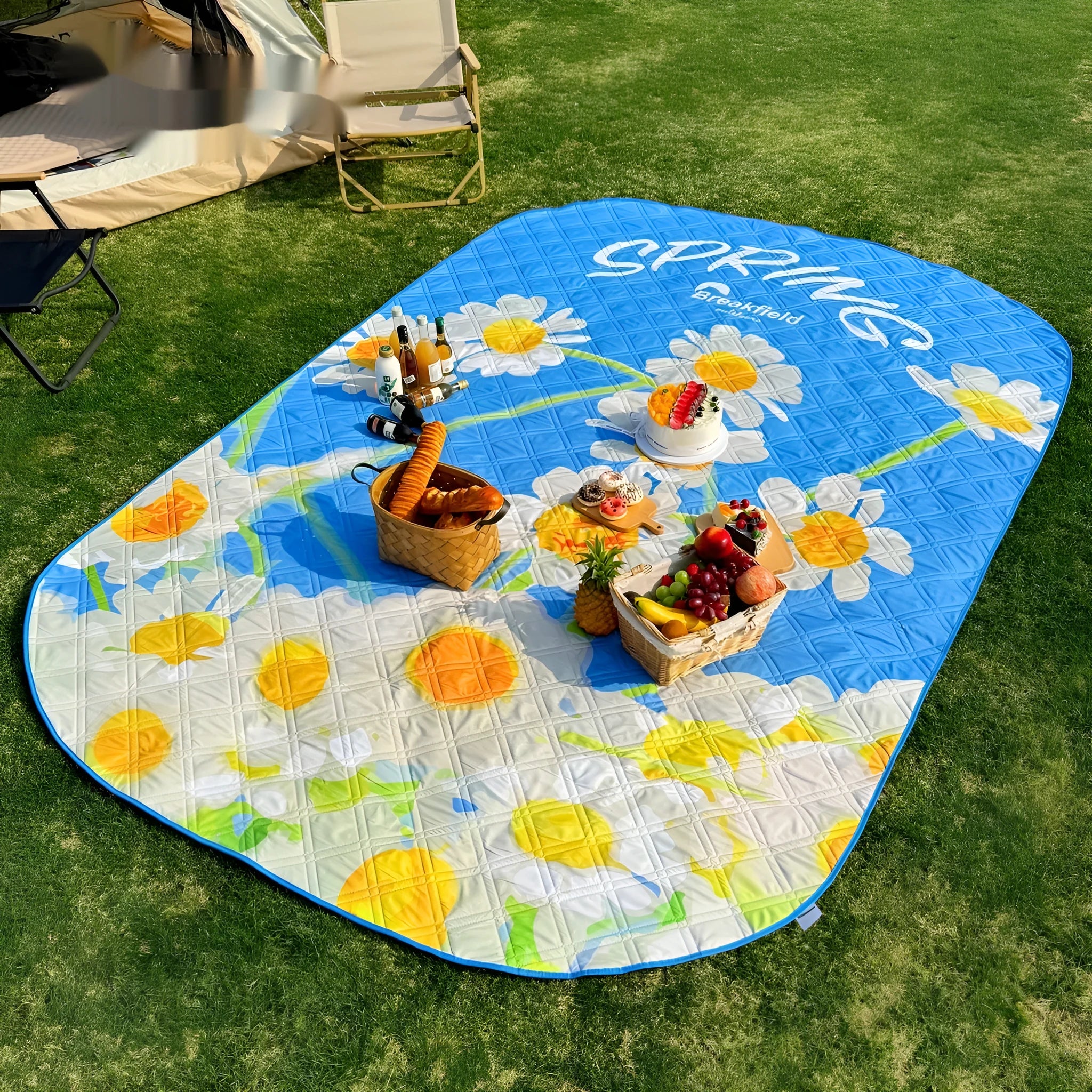 Waterproof thickened outdoor picnic mat in a Four Seasons colour, shown unrolled on grass.