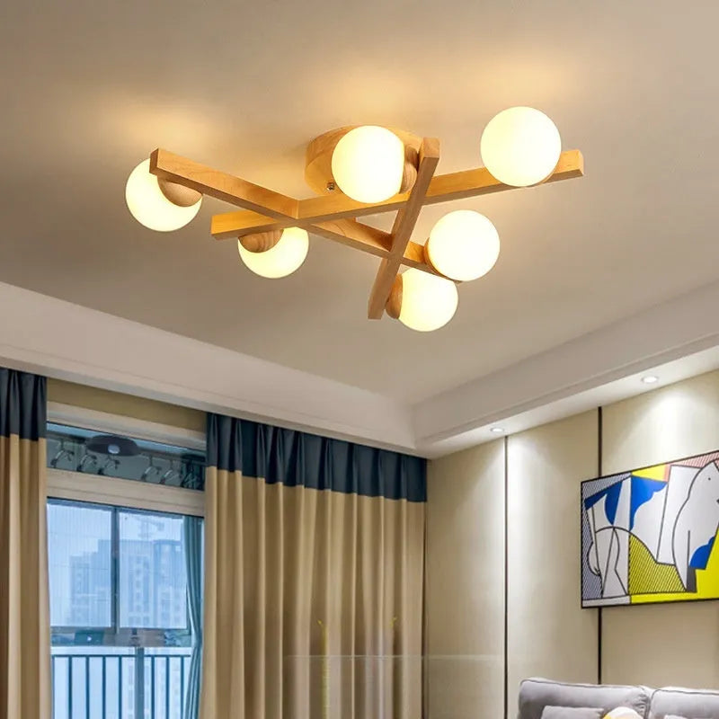 Modern Nordic-style ceiling light with wooden accents and three white lamp heads mounted on a clean, white ceiling.