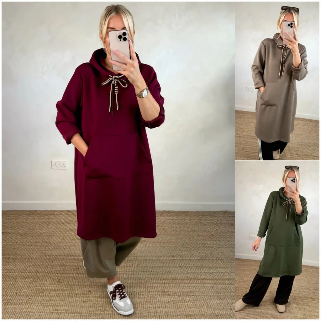 Woman wearing loose oversized knit hooded maxi dress in solid colour with front pockets, pullover style, black colour option