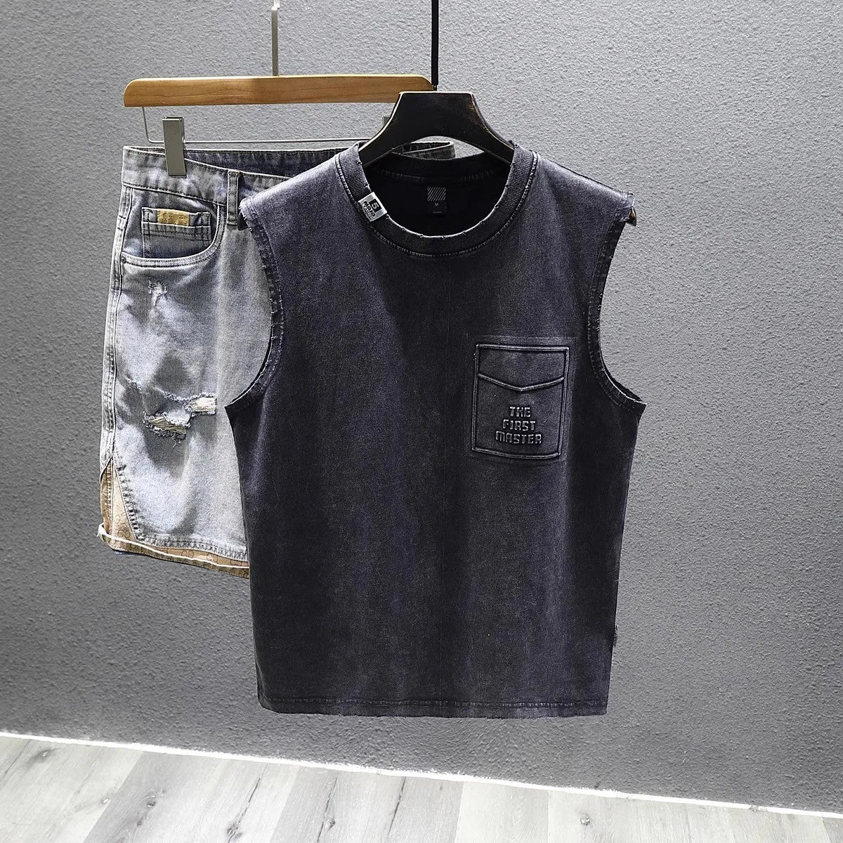 Men's solid black loose fit cotton sleeveless t-shirt with a straight hem.