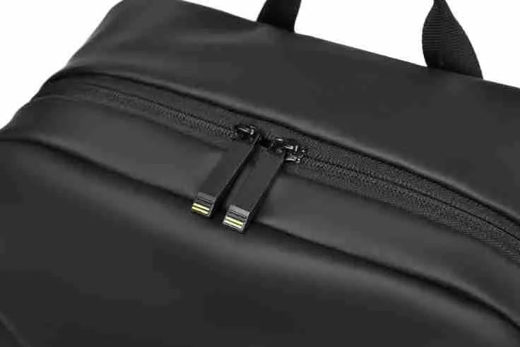 Men's large waterproof PU leather backpack in grey colour with visible stitching and laptop compartment.