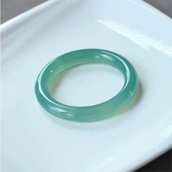 Natural agate wide tire bracelet shown in pink, available in sizes 52mm to 62mm.