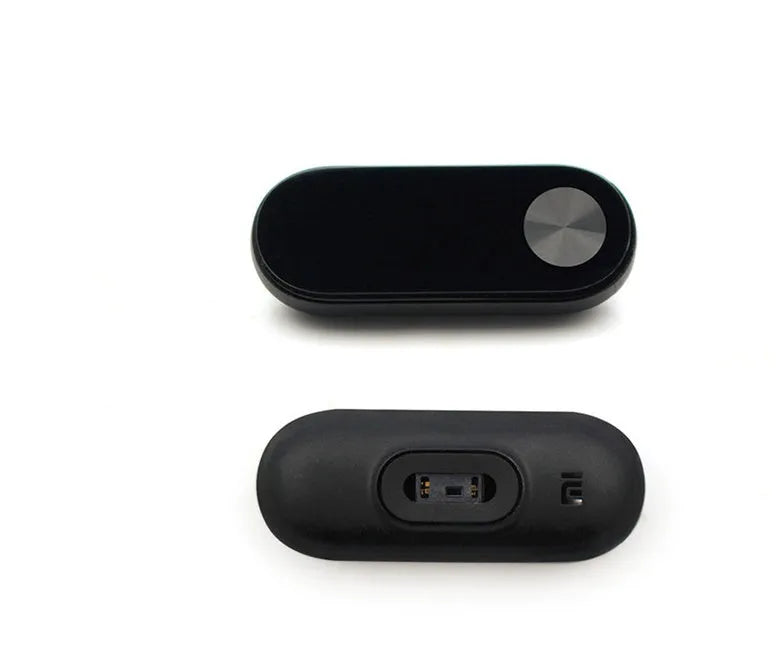 Xiaomi Mi Band 2 black fitness tracker on wrist showing OLED display with heart rate reading.