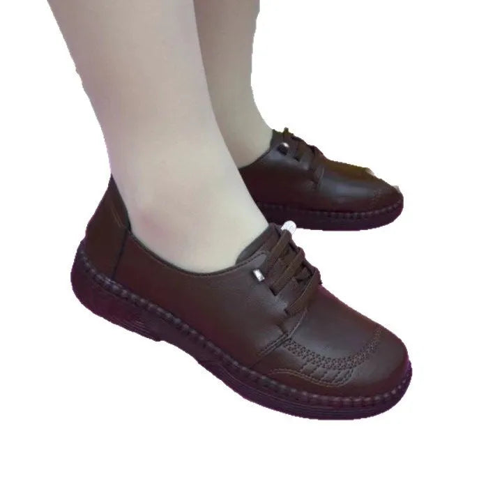 Women's soft leather low heel shoes in black with front lace-up and non-slip rubber sole
