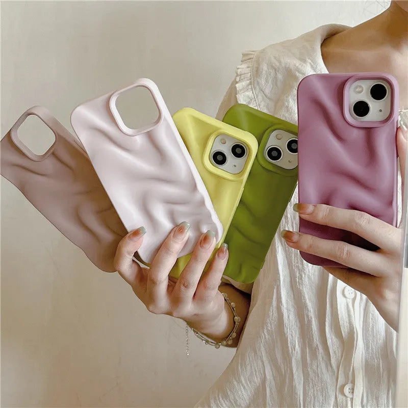 Three-dimensional pleated water ripple TPU phone case for iPhone 14 in glossy silver, showing textured back and edge coverage