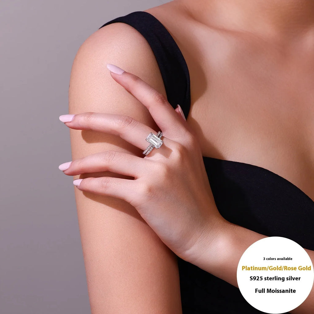 Pair of matching geometric S925 sterling silver rings with white finish on a flat surface