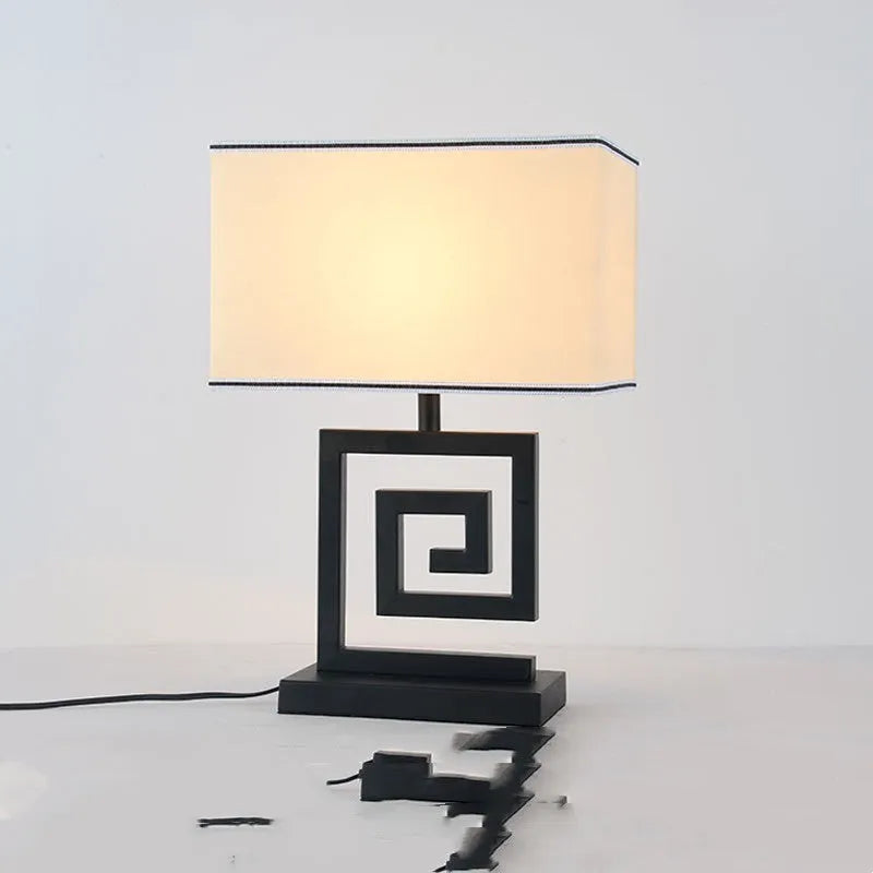 Retro style table lamp with fabric lampshade, iron frame, and remote control switch on a bedside table
