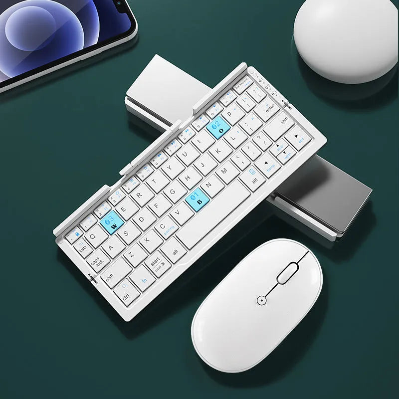 Silver white folding Bluetooth keyboard open with stand holding a smartphone, shown next to its compact folded size.