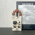 Square vertical cartoon knitted messenger bag with woven polyester construction and internal phone pocket