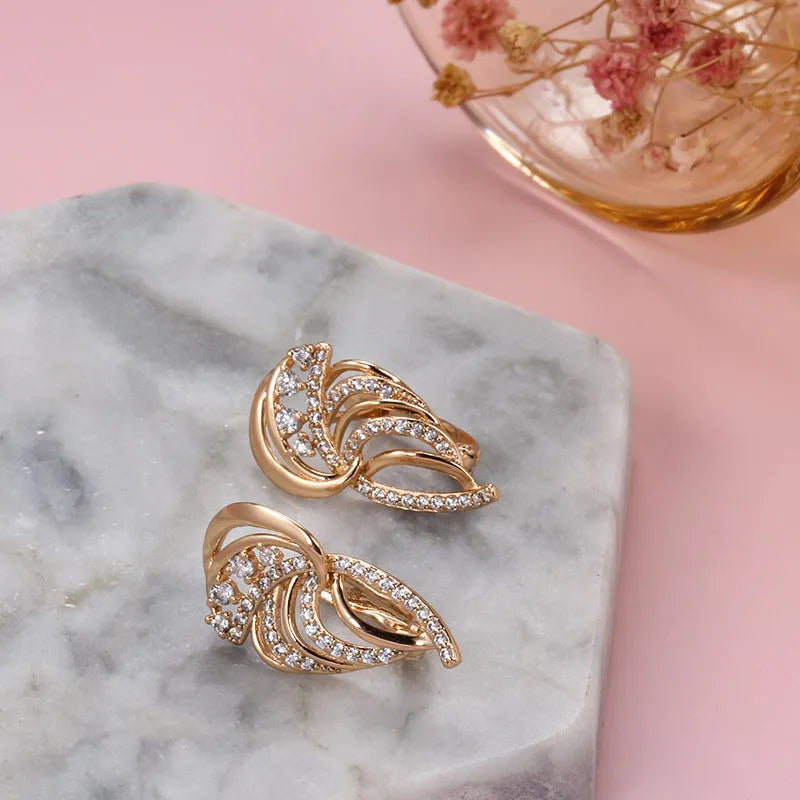 Gold-plated copper women's ear clips with wing design and micro inlaid zircon stones.