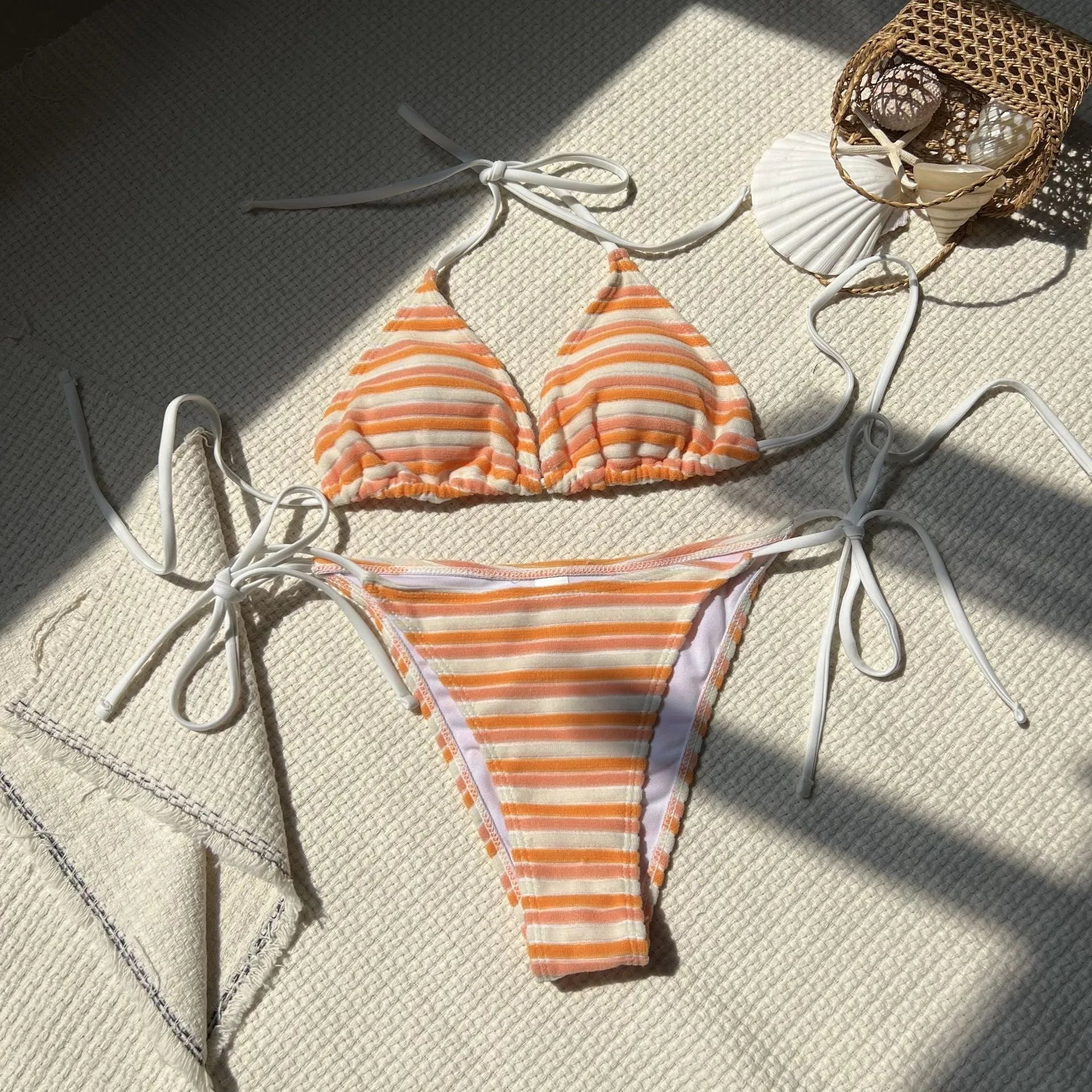 Women's striped split bikini set in pink, made from polyester, with briefs style pants